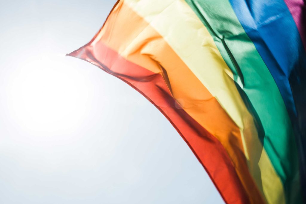 The rainbow flag flying in the wind